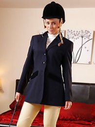 KiloTeens presents: Clare R seductifvely removes her riding gear leaving on only opaque hold ups and sheer underwear
